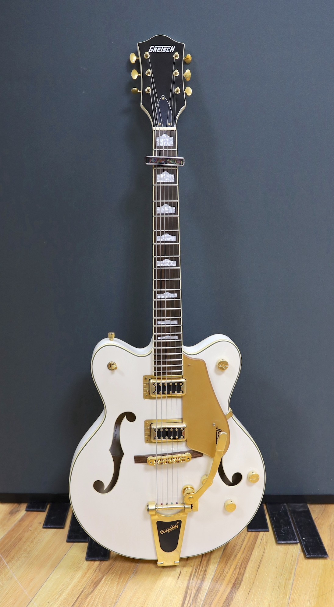 A Gretsch Bigsby electromatic guitar with case